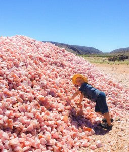 Our son with a pile of Natural Rose Quartz Crystal in the Northern Cape of South Africa on a Crystal hunting trip